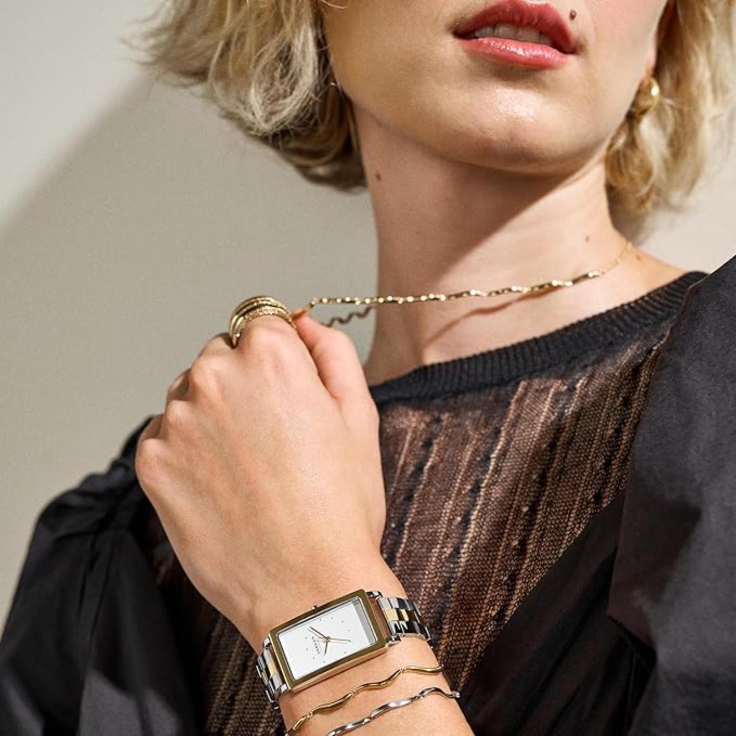 Skagen Hagen Lille SKW3156 women’s minimalist rectangular dress watch with two-tone bracelet worn on wrist in elegant lifestyle setting.