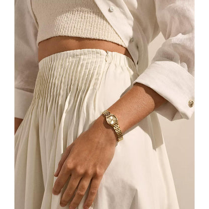 Skagen Mellem Micro SKW3177 worn on the wrist with gold-tone case, sunray dial, slim hour markers, side crown, and gold-tone stainless steel bracelet.