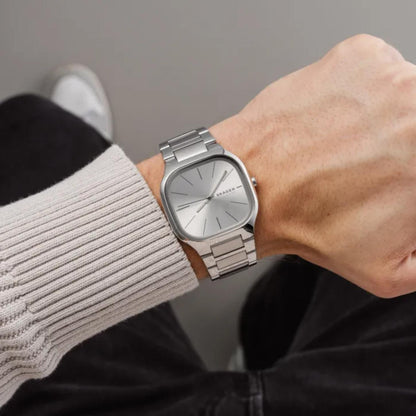 Skagen Mellem SKW6934 women’s minimalist stainless steel watch with silver dial and integrated bracelet worn on wrist in casual lifestyle setting.