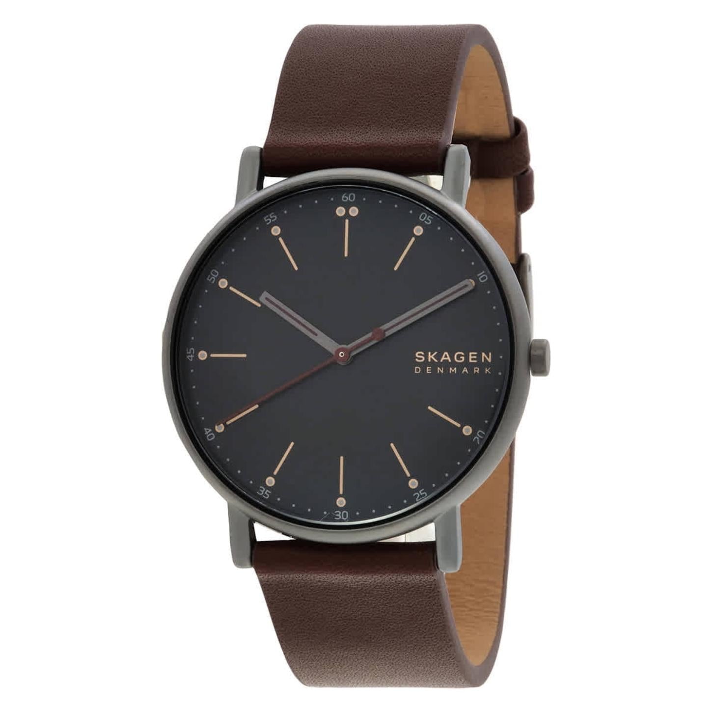 Skagen SKW6860 minimalist watch with black dial, slim gunmetal-tone case, rose gold-tone markers, and brown leather strap.
