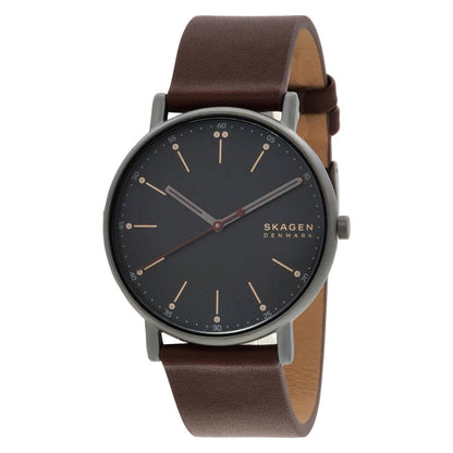 Skagen SKW6860 minimalist watch with black dial, slim gunmetal-tone case, rose gold-tone markers, and brown leather strap.