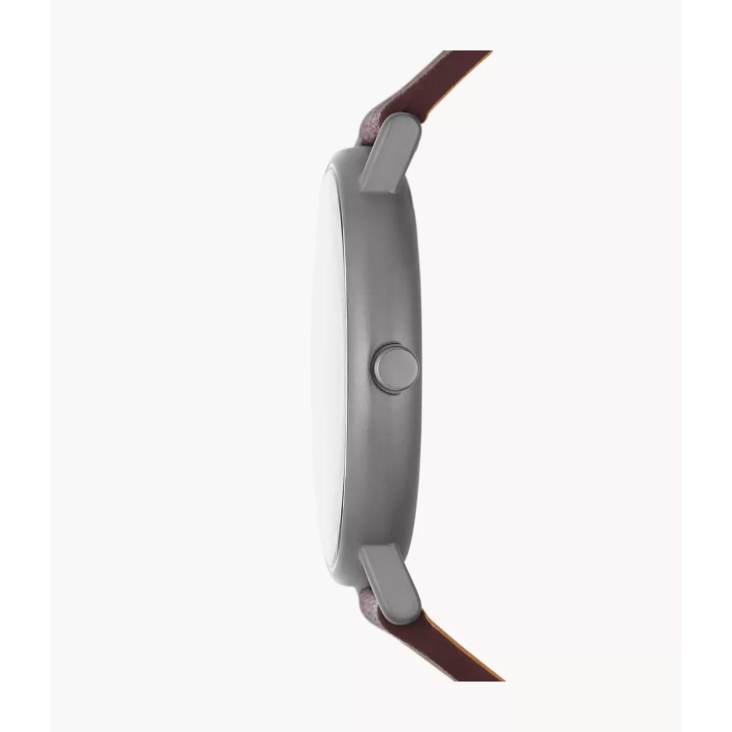 Skagen SKW6860 with ultra-slim gunmetal-tone case profile, minimalist crown, and brown leather strap attachment.