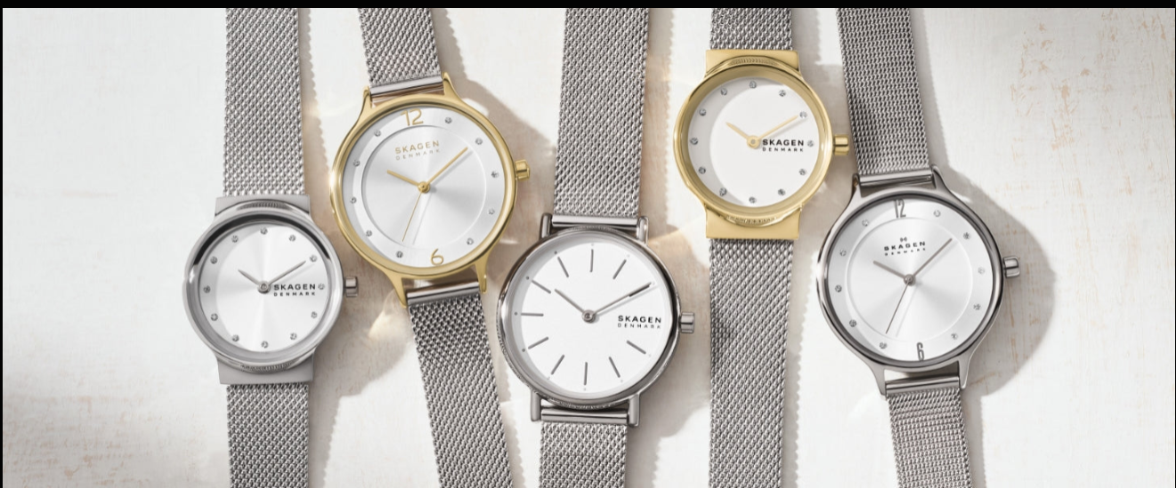 Skagen women’s watches with minimalist white dials, slim cases, and silver and gold-tone mesh bracelets in clean Scandinavian style