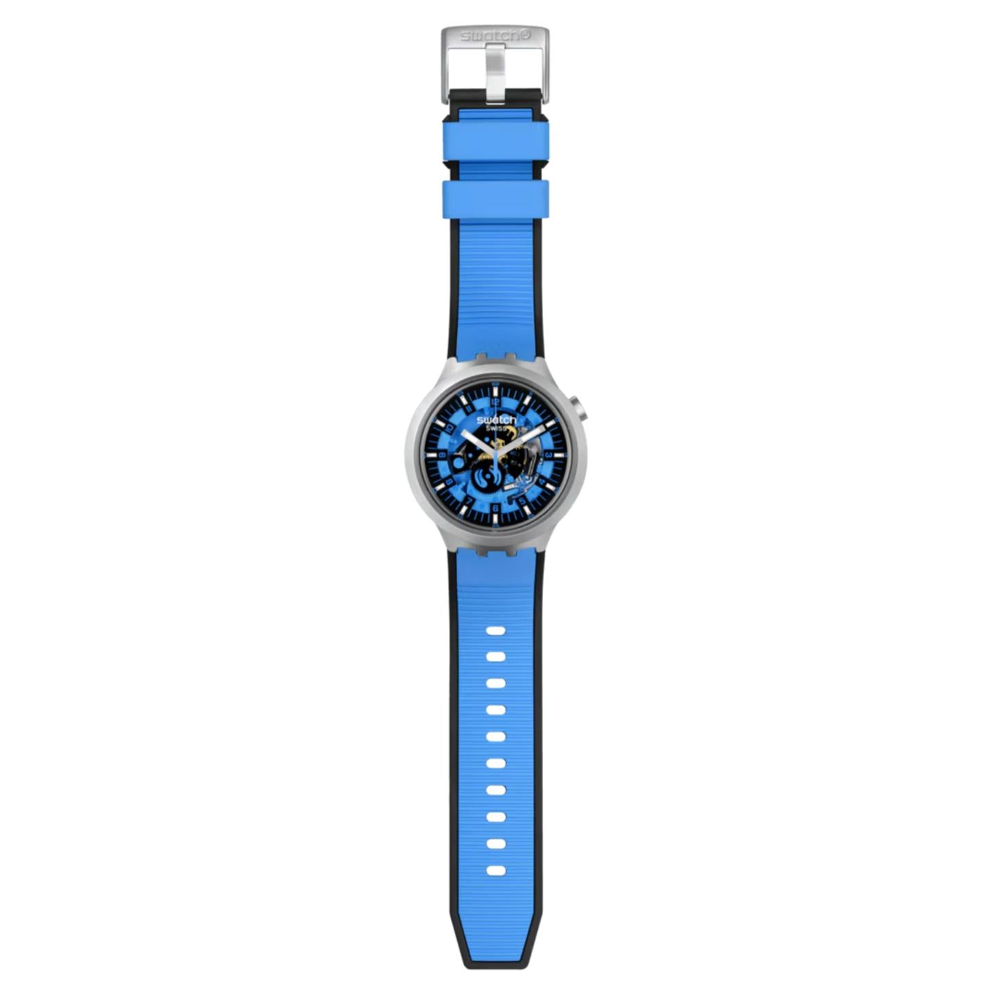 Swatch Big Bold Irony SB07S106 watch with a blue openworked dial, gray case, full-length blue strap, adjustment holes, and metal buckle.