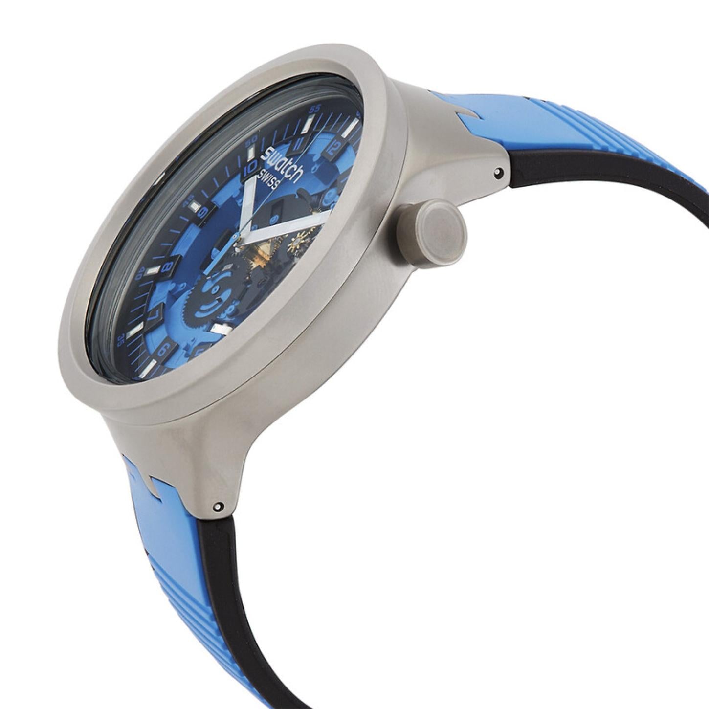 Swatch Big Bold Irony SB07S106 watch in side profile with a gray case, prominent crown, blue openworked dial, and blue strap with black lining.