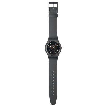 Swatch Cobblestone Street SO29A101 with gray patterned dial, light blue hour markers, red hands, full dark gray strap with adjustment holes, and matching buckle.
