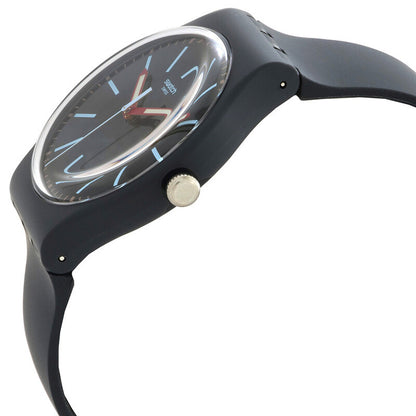 Swatch Cobblestone Street SO29A101 with gray dial, light blue hour markers, red hands, dark gray case, silver-tone crown at 3 o’clock, and matching dark gray strap.