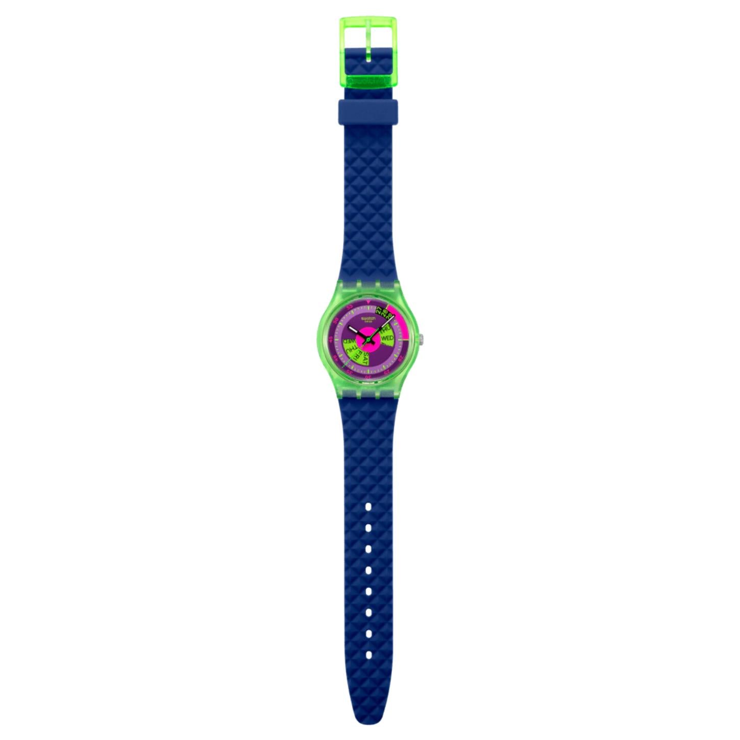 Swatch Neon Skychart SO28G704 watch with a purple dial, translucent green case, full-length textured blue strap, adjustment holes, and translucent green buckle.