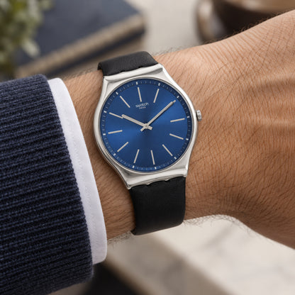 Swatch Skin Irony Formal Blue SS07S125 worn on the wrist with blue sunray dial, slim silver-tone hour markers and hands, polished silver-tone case, and black strap.