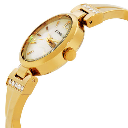 Timex Dress TW2U70000 with a mother-of-pearl dial, gold-tone oval case, textured crown, and crystal-accented gold-tone bracelet details.