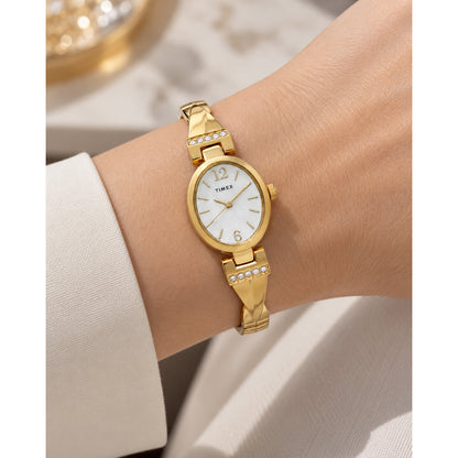 Timex Dress TW2U70000 with a mother-of-pearl dial, gold-tone oval case, crystal-accented bracelet details, and matching gold-tone bracelet worn on the wrist.