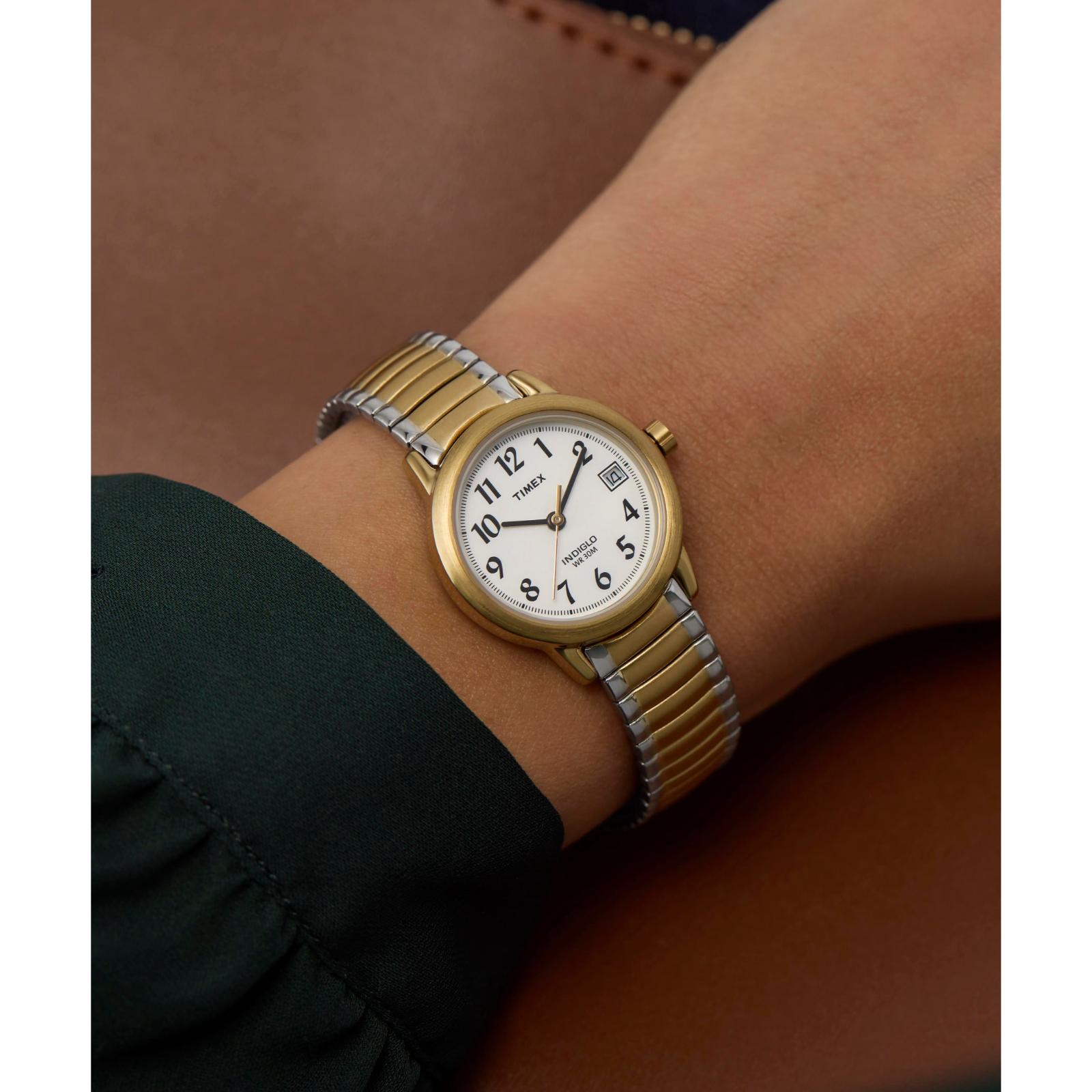 Timex Easy Reader 25mm women’s watch with white dial, gold-tone case, and two-tone expansion bracelet worn on the wrist.