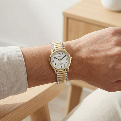 Timex Easy Reader 25mm women’s watch with white dial, gold-tone case, and two-tone expansion bracelet worn on the wrist.