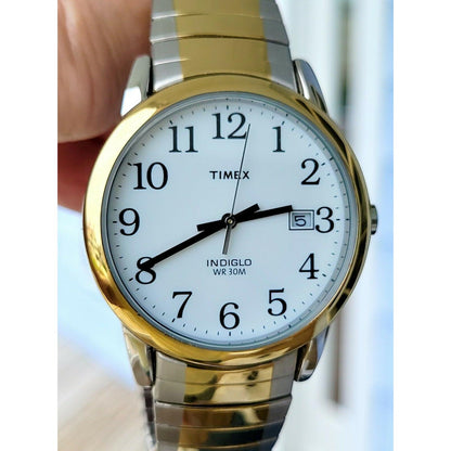 Timex Easy Reader 35mm T2H311 close-up showing the white dial, black Arabic numerals, gold-tone bezel, and two-tone expansion bracelet.
