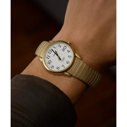 Timex Easy Reader 35mm men’s watch worn on wrist with white dial, black Arabic numerals, day-date window and gold-tone expansion bracelet.