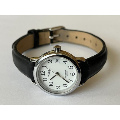Timex Easy Reader T2H331 women’s watch with white dial, silver-tone case, date window, and black leather strap displayed on a flat surface.