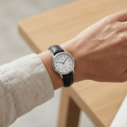 Timex Easy Reader T2H331 women’s watch with white dial, silver-tone case, and black leather strap worn on the wrist.