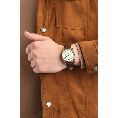 Timex Easy Reader TW2P75800 men’s watch with cream dial and brown leather strap worn on the wrist with a casual brown jacket.