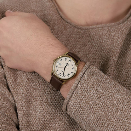 Timex Easy Reader TW2P75800 men’s watch with cream dial, gold-tone case, and brown leather strap worn on the wrist.