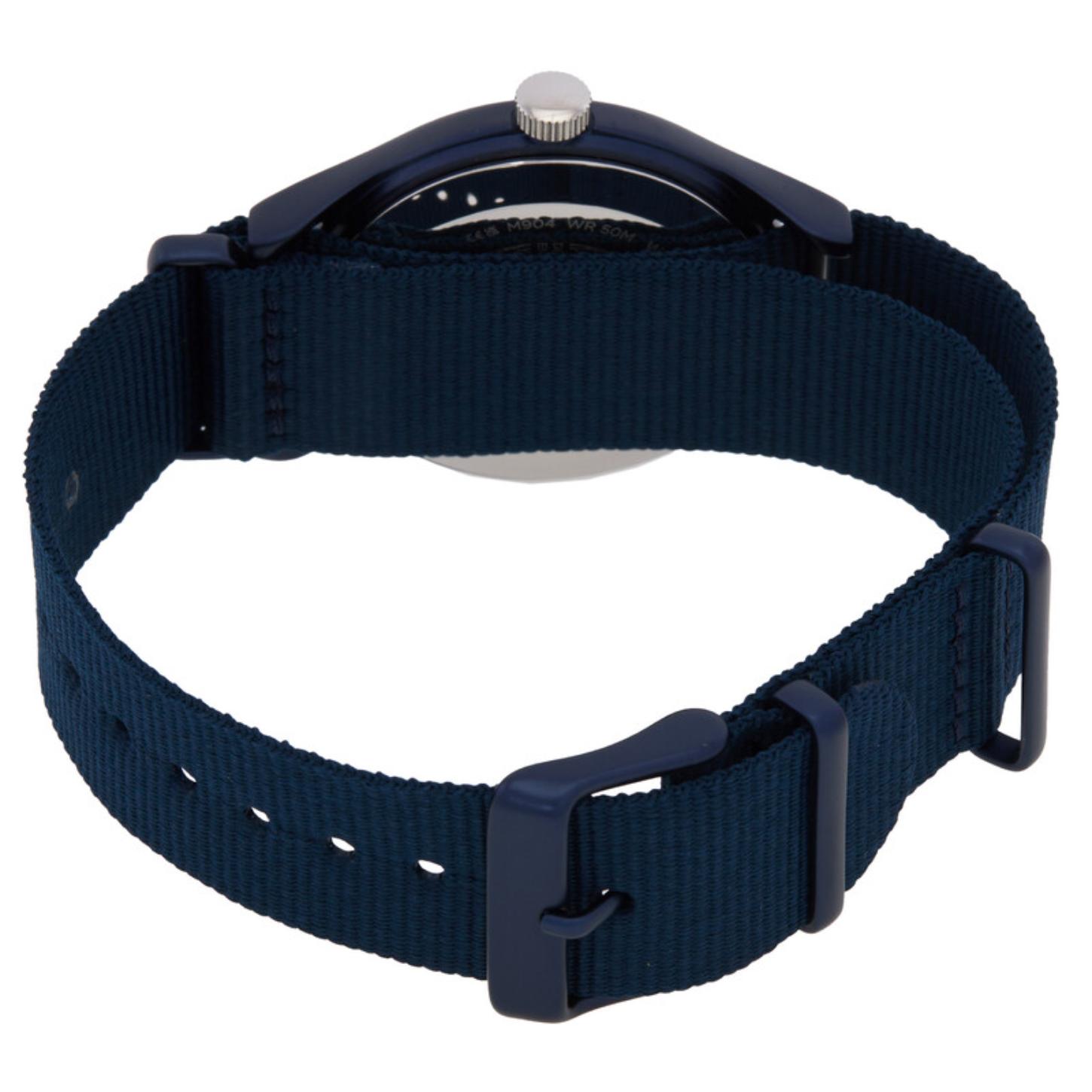 Timex MK1 TW2R37300 from the back with a blue woven fabric strap, matching blue-tone buckle and keepers, silver-tone crown, and partially visible caseback.