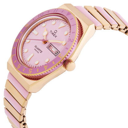 Timex Q Timex TW2W87600VQ with a pink dial, pink bezel, gold-tone case and crown, day-date window, and gold-tone bracelet with pink accents.