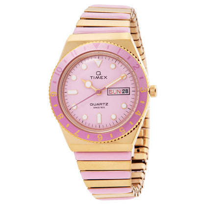 Timex Q Timex TW2W87600VQ with a pink dial, pink bezel, gold-tone hands and markers, day-date window, and gold-tone bracelet with pink center links.