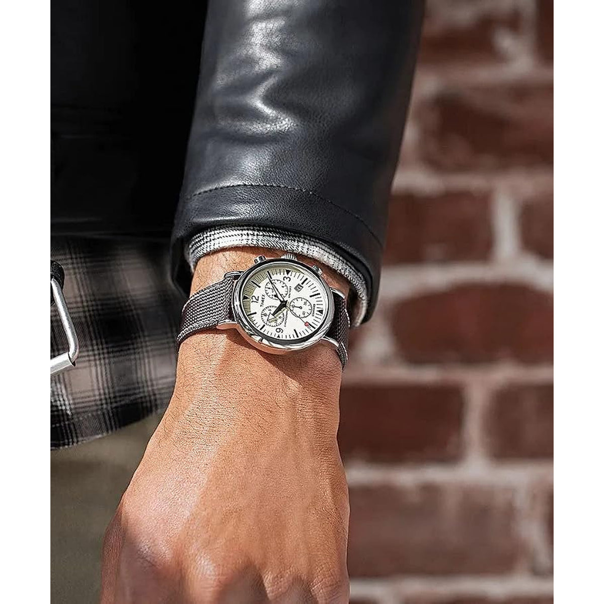 Timex Standard Chronograph TW2V43800 with a cream chronograph dial, silver-tone case, and black textured strap worn on the wrist.