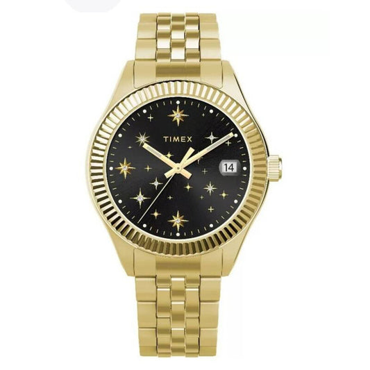 Timex Waterbury Celestial Legacy TW2W21700 with black celestial dial, gold-tone star markers and hands, fluted bezel, date window at 3 o’clock, and matching gold-tone bracelet.