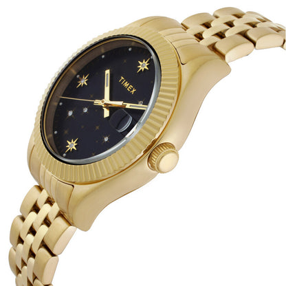 Timex Waterbury Celestial Legacy TW2W21700 with black celestial dial, gold-tone star markers and hands, fluted bezel, crown at 3 o’clock, and matching gold-tone bracelet.