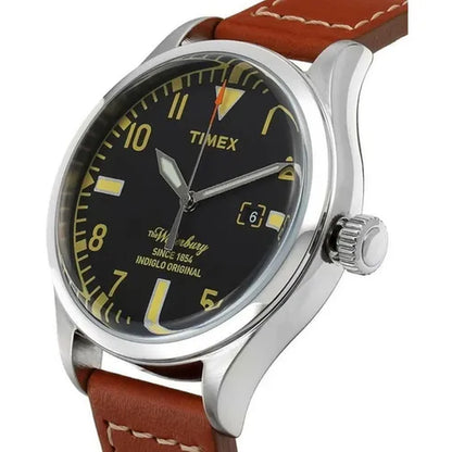 Timex Waterbury TW2P84000 with black dial, cream-tone numerals and markers, silver-tone case, date window, crown at 3 o’clock, and brown leather strap with contrast stitching.