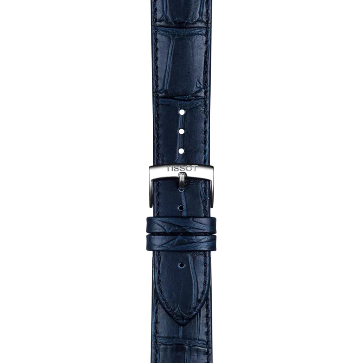 Close-up of the blue alligator-grain leather strap and stainless steel buckle of the Tissot Carson Premium Powermatic 80 T122.407.16.043.00, highlighting the premium leather texture, stitching, and signed Tissot clasp.