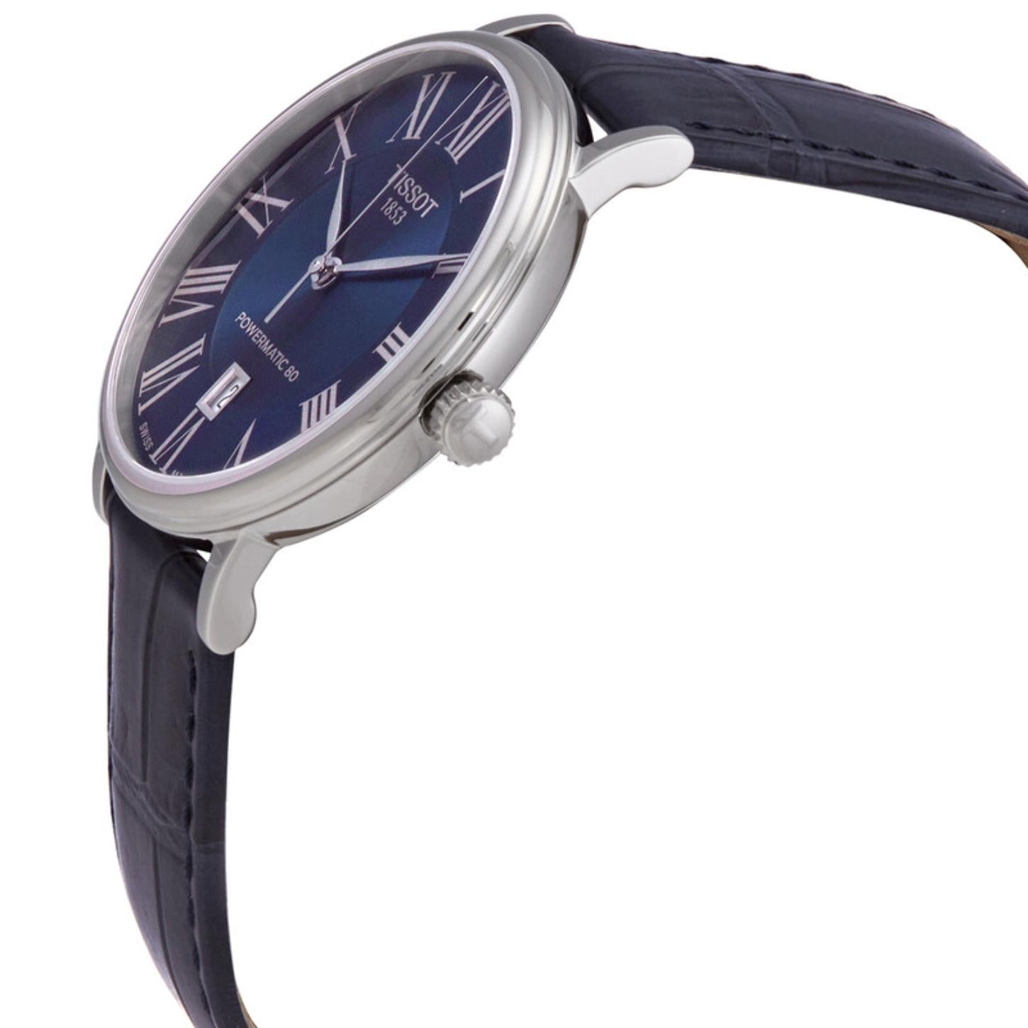 Side profile of the Tissot Carson Premium Powermatic 80 T122.407.16.043.00 showing the slim stainless steel case, polished crown, sapphire crystal, and blue alligator-grain leather strap.