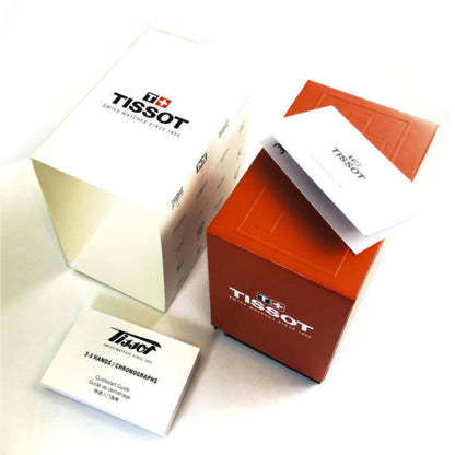 Original Tissot watch packaging set with red presentation box, branded outer sleeve and chronograph instruction manuals.