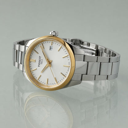 Tissot PR 100 T150.210.21.031.00 women’s Swiss quartz watch with white dial, gold-tone bezel accents and two-tone stainless steel bracelet shown in angled profile view.