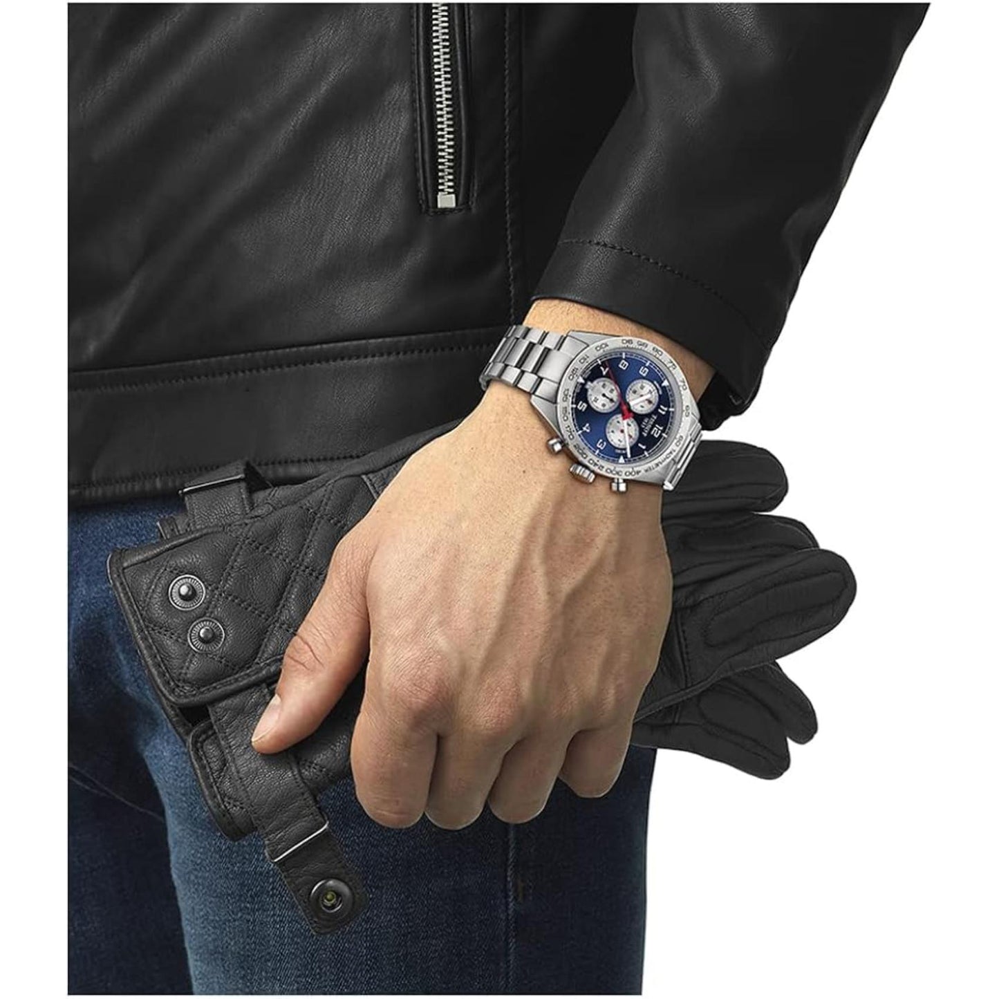 Tissot PRS 516 Chronograph T131.617.11.042.00 Swiss sport watch worn on wrist with blue dial, tachymeter bezel, chronograph subdials and stainless steel bracelet paired with black leather jacket.