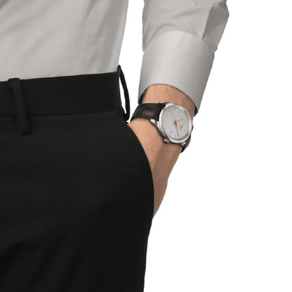 Tissot T150.410.16.031.00 dress watch worn on the wrist with silver dial and brown leather strap.