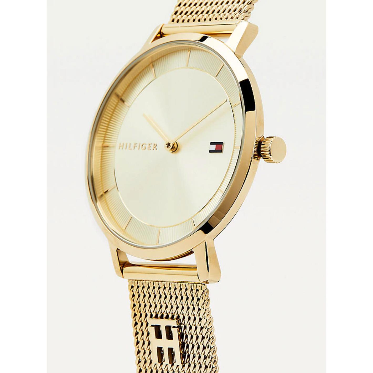 Reloj Tommy Hilfiger 1782286 para mujer en color dorado con pulsera de malla metálica y esfera champán, vista lateral de la caja.