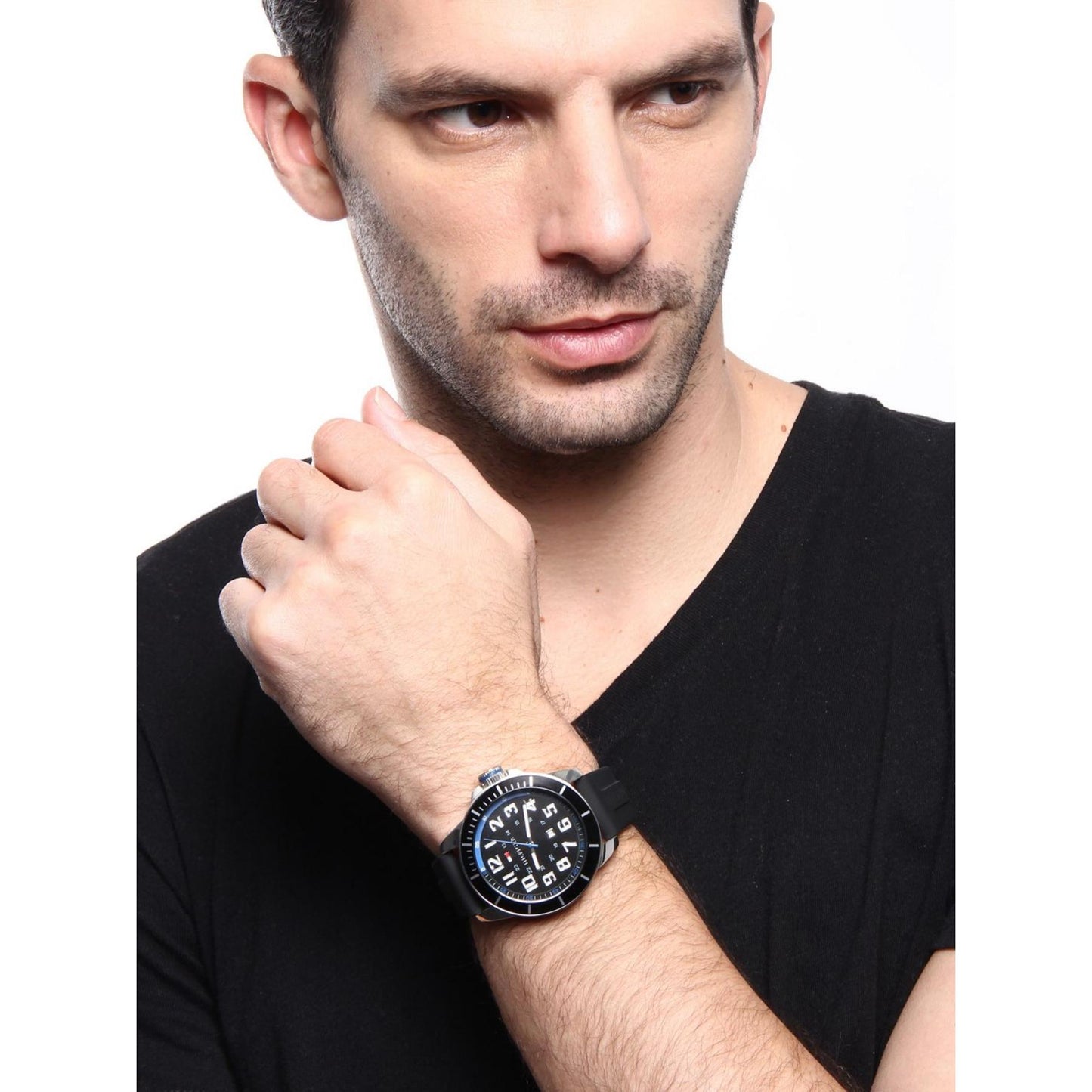 Tommy Hilfiger 179102 men’s sport watch with black dial and black silicone strap worn on the wrist with a casual black outfit.