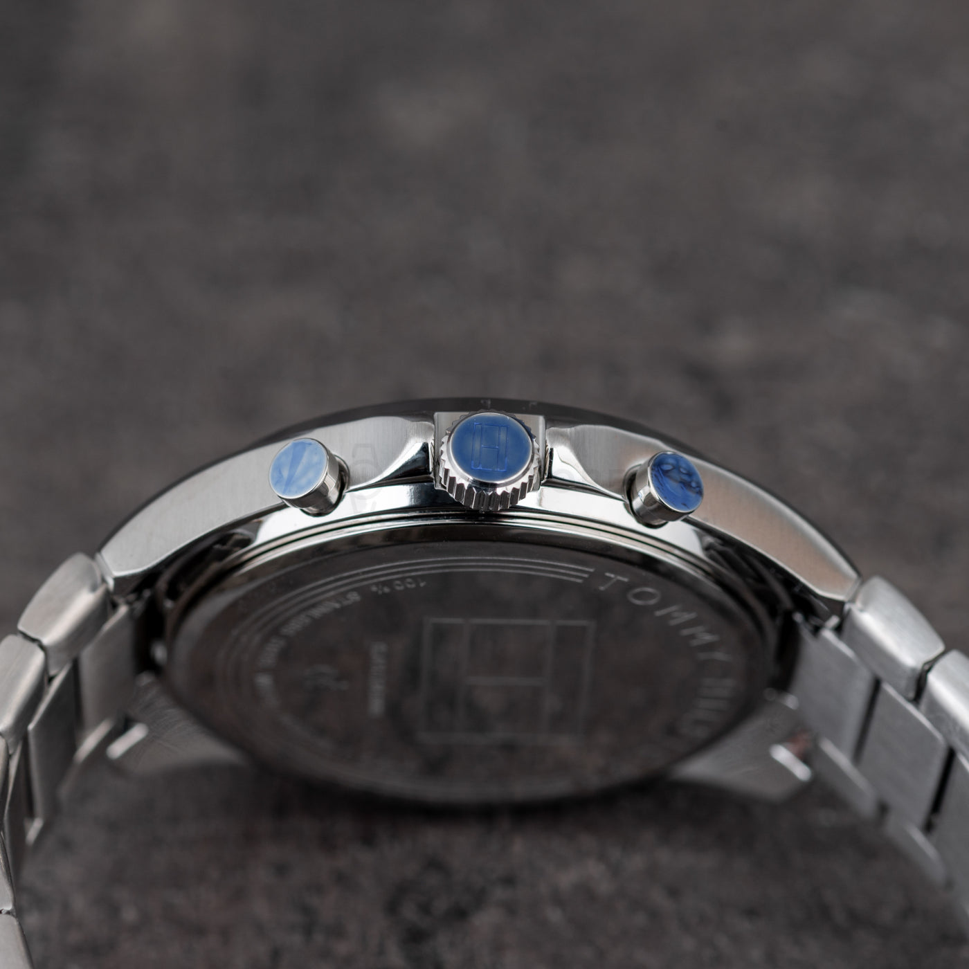 Tommy Hilfiger 1791348 crown and pushers detail with stainless steel case and blue accents on the buttons.