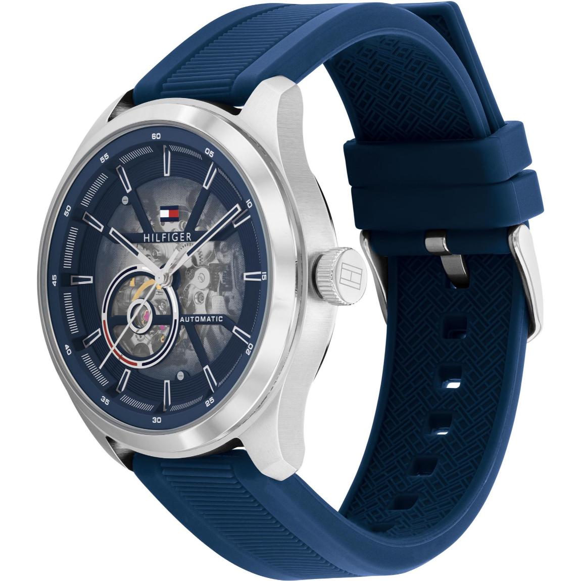 Tommy Hilfiger 1791885 men’s automatic watch with blue skeleton dial, silver-tone case, and textured blue silicone strap shown in an angled view.