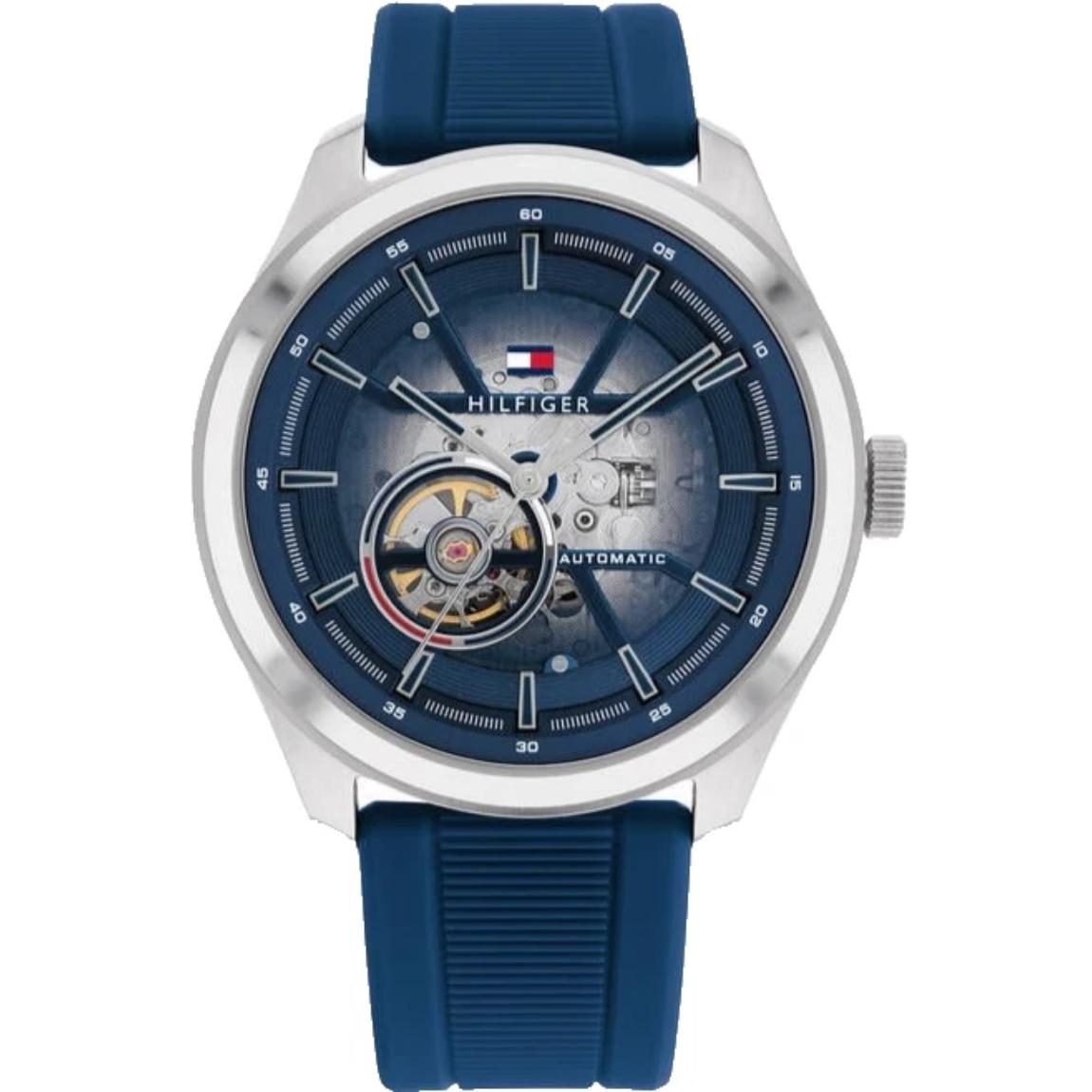 Tommy Hilfiger 1791885 men’s automatic watch with blue skeleton dial, open-heart movement display, silver-tone case, and blue silicone strap.