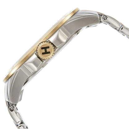 Vista lateral del reloj Tommy Hilfiger bicolor, mostrando la caja de acero, el bisel dorado y la corona dorada con la letra H grabada.